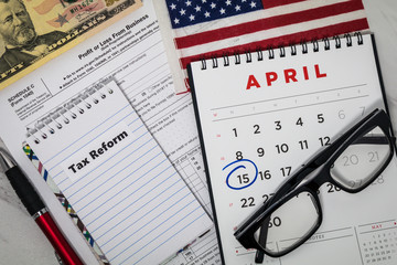 Filing Taxes still life business finance concept with calculator and tax forms, flat lay