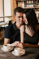 Loving couple hugging in the cafe.