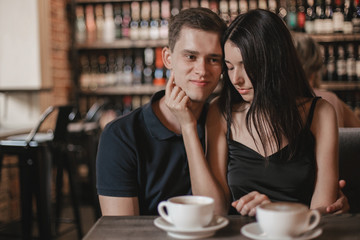 Loving couple hugging in the cafe.