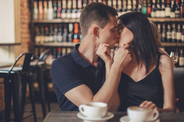 Loving couple hugging in the cafe.