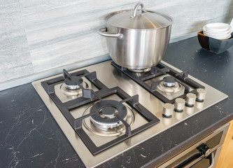 Metal Pot on induction hob in modern kitchen. modern kitchen pot cooking induction electrical stove hob concept