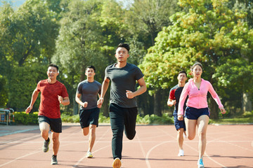 young asian athletes training on track