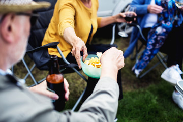 People passing around a bowl of chips