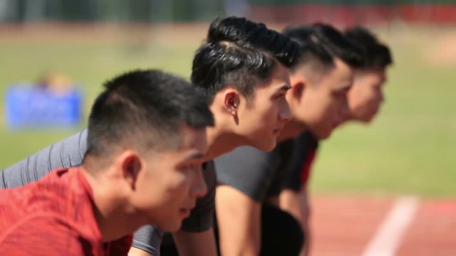 young asian sprinters on starting line