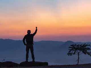 Fototapeta premium Silhouette of hiker man on top of mountain. successful people concept