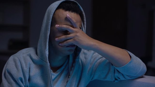 Afro-american teenager looks guilty, ashamed and frustrated, anxiety and stress