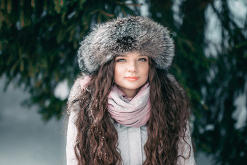 fur hat beaty girl winter near spruce