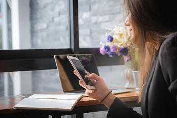 Beautiful businesswoman using smartphone device in hands. Business technology concept.