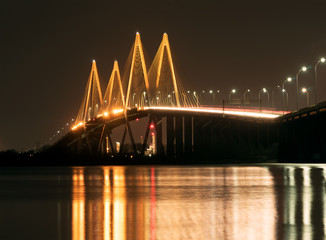 Fototapeta na wymiar The Fred Hartman Bridge is a cable-stayed bridge in the U.S. state of Texas spanning the Houston Ship Channel. The bridge is the longest cable-stayed bridge in Texas. Night photography