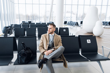 Business man with suitcase in hall of airport