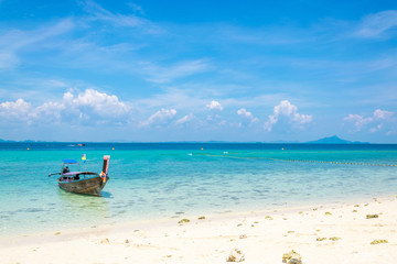 Fototapeta na wymiar A Thai long tail boat on the beach of Andaman sea located at Krabi near Phuket, Thailand