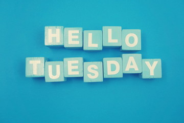 Hello Tuesday alphabet letters on blue background
