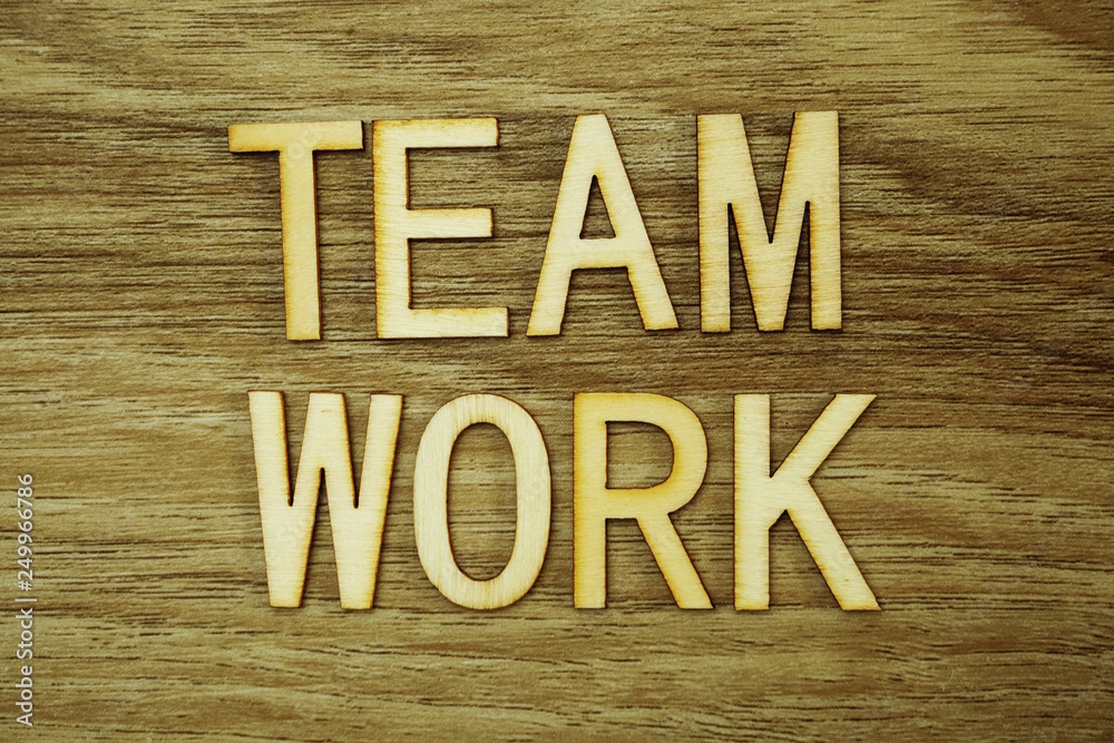 Wall mural teamwork text message on wooden background