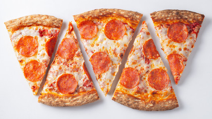pepperoni pizza slices on white background. top.