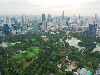 Aerial view city public park with modern building and fog