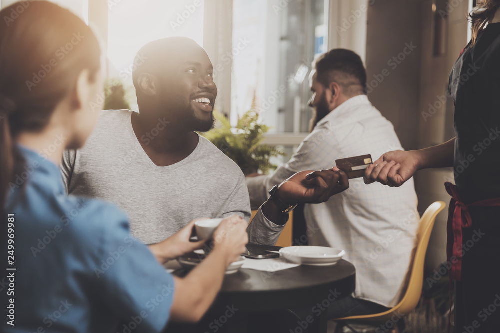 Wall mural young african american is calculated credit card