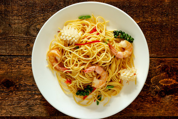 spicy spaghetti with seafood on plate.