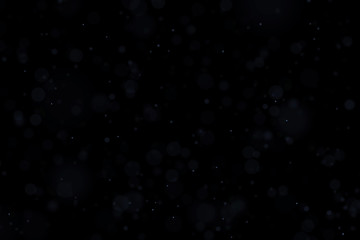 Floating light atmospheric particles isolated on black overlay. May be used on top of the layers in...