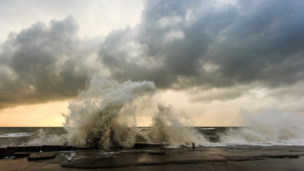 Fototapeta na wymiar Storm waves over a pier in the Adler, Sochi