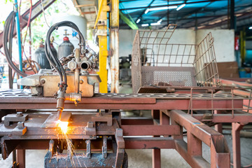 Close up torch or tip and flame with sparkle form oxygen and acetylene of gas cutting machine for industrial at factory