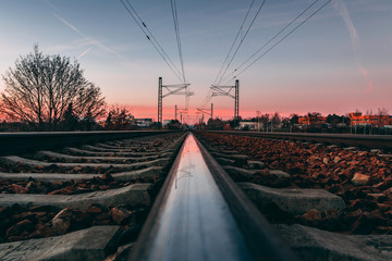 Metal tracks with raiload tie on railway in sunset