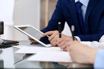 Businessman using laptop at meeting, closeup of hands. Business operations concept