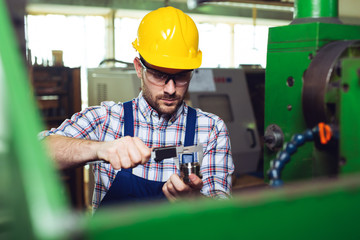 Supervisor doing quality control and production check in factory 