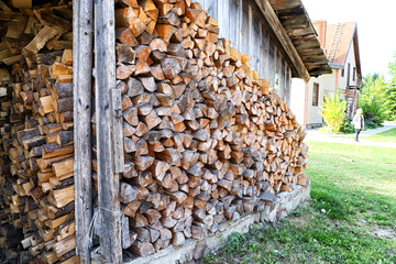 Wood in the woodpile in the village in summer