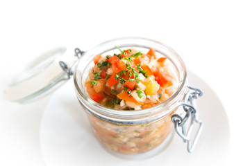 Fresh salsa dip in a jar isolated on white background