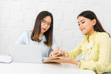 Two Asian architect ladies at office