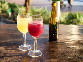Red and white sangria on wodden table outside restaurant during sun set in Singapore