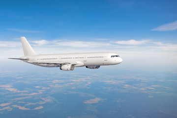 Fototapeta na wymiar White plane on flight level above ground