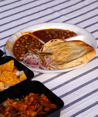 Indian street vendor display bread and chana or green peas curry in a plate