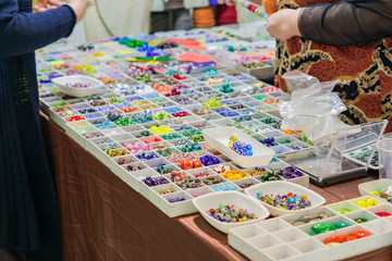 Colorful mix of lampwork glass beads. Variety of shapes and colors to make necklaces or bracelets. DIY materials at the market