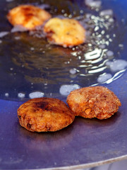 closeup View of deep frying in pan and oil Indian street food vegetable cutlets 