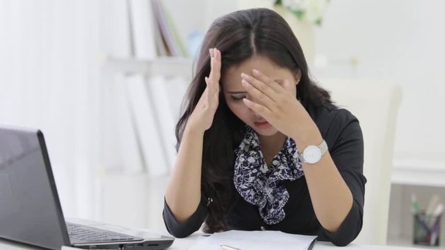 unhappy businesswoman while working in her office