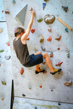 Teenage Boy Training On Climbing Wall