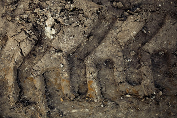 Close up imprint on the ground from tractor tires