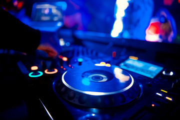 Obraz na płótnie Canvas DJ playing music at mixer closeup