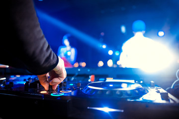 DJ playing music at mixer closeup