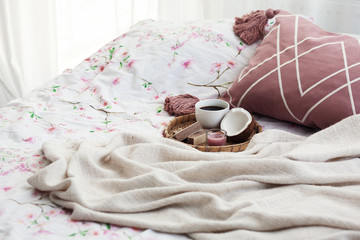 Fototapeta na wymiar cup of morning coffee, waffles and coconut, breakfast , weekend in a cozy bed