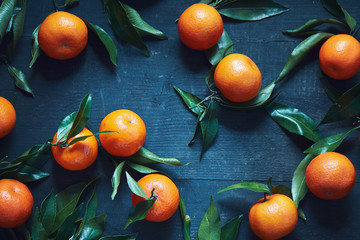 Fresh tangerines with stems and leaves
