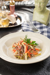Beef salad with fresh tomatoes, bell pepper and pear served for lunch on the table
