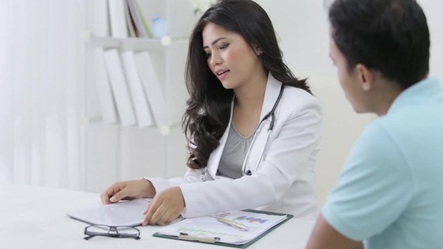 beautiful female doctor talk to her patient about some prescription