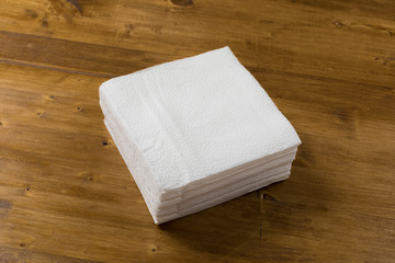 white paper napkin on wooden background.