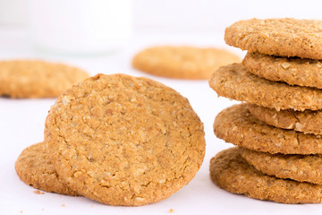 Homemade shortbread cookies made of oatmeal are stacked on a white table background. Food snack concept and with copy space for text.