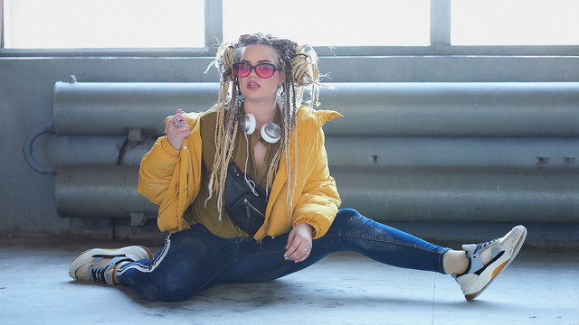portrait of an eccentric modern young woman, bright make-up sunglasses, and a crazy hairstyle. м