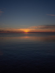 Sunset on the water. Vertical landscape.