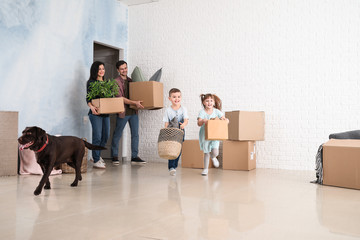 Family with cardboard boxes after moving into new house