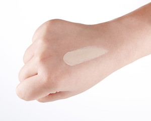 cosmetic foundation cream texture on back of one's hand. cosmetic cream.